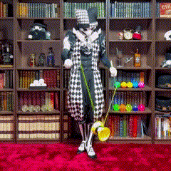 a man in a clown costume is holding a broom in front of a bookshelf