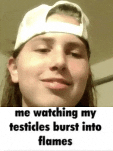 a girl wearing a baseball cap is watching her testicles burst into flames