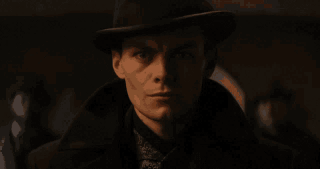 a close up of a man wearing a hat