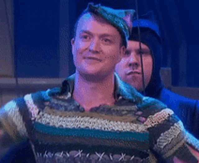 a pixelated image of a man in a sweater with the letters x and y on it