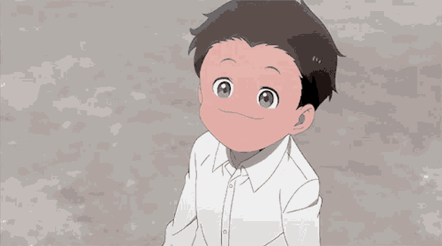 a young boy in a white shirt is smiling and waving his hands in the air