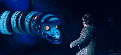 a man is being attacked by a giant snake with a huge mouth