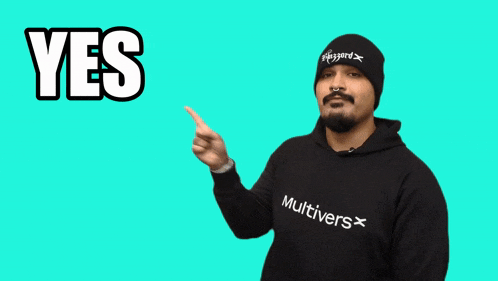 a man wearing a black multivers sweatshirt is pointing
