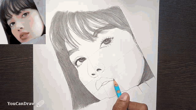 a drawing of a woman 's face is being drawn by a person named youcandraw