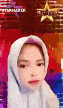 a girl wearing a white hijab with a starmaker logo behind her