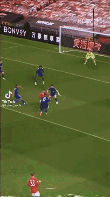 a soccer game is being played in front of a marriott banner