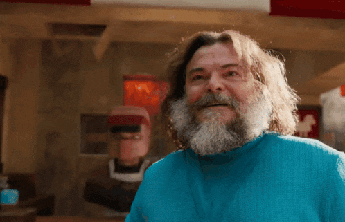 a man with a beard wearing a blue shirt