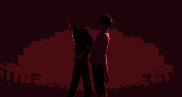 a couple of anime characters standing next to each other and hugging each other .