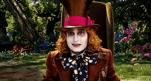 the mad hatter from alice in wonderland is wearing a red hat