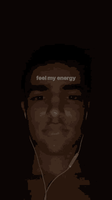 a man wearing ear buds with the words " feel my energy " above his head