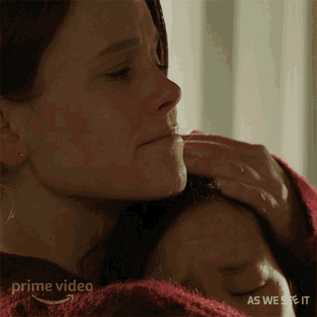 a close up of a woman holding a child with the words prime video as we see it