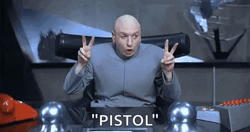 a bald man is sitting at a desk giving a peace sign and saying `` pistol '' .