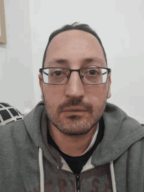 a man wearing glasses and a hoodie that says ' abercrombie & fitch ' on the front