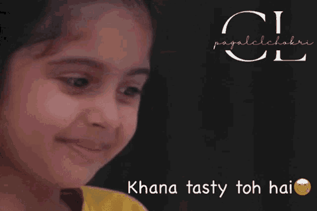 a little girl is smiling with the words khana tasty toh hai