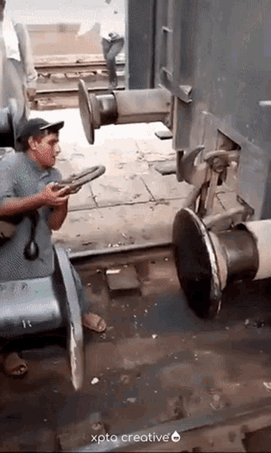 a man is working on a train with the caption xpto creative on the bottom