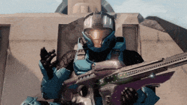 a man in a blue helmet is holding a gun and giving a high five