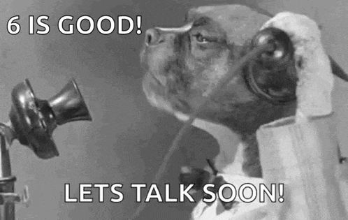 a black and white photo of a dog talking on a phone .