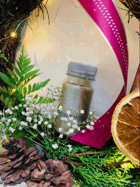 a bottle of sun shot is surrounded by pine cones