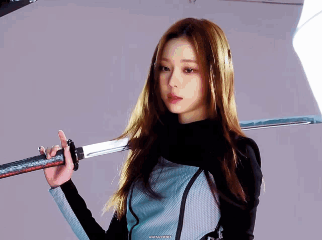 a woman holds a sword over her shoulder and the word winter is on the bottom right