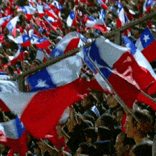 a crowd of people are waving red white and blue flags in a stadium
