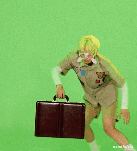 a man in a safari outfit is running with a briefcase in front of a green screen