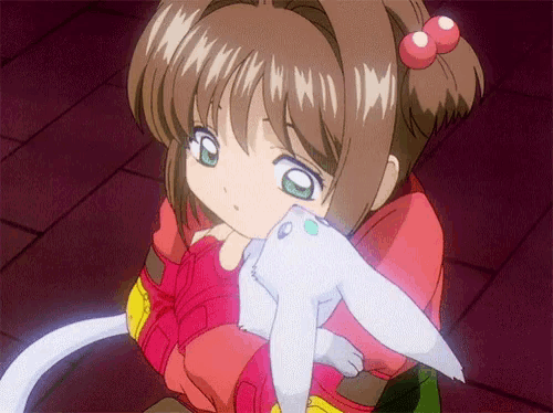 a girl in a red shirt is holding a white stuffed animal