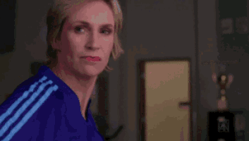 a woman wearing a purple shirt with the word outstanding written on it