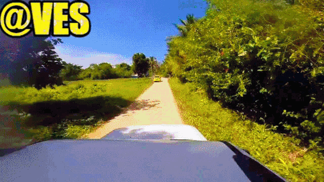 a car is driving down a dirt road with the words @ves written on the top