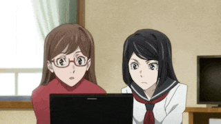 two anime girls are looking at a laptop screen together