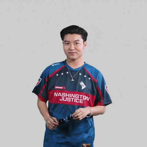 a man wearing a washington justice jersey holds sunglasses