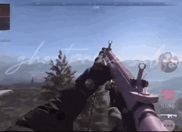 a person is playing a video game with a pink gun .