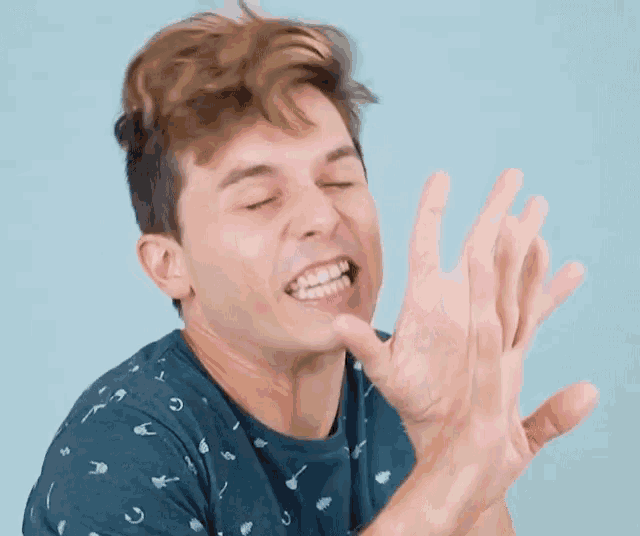 a man making a funny face with his hands in the air