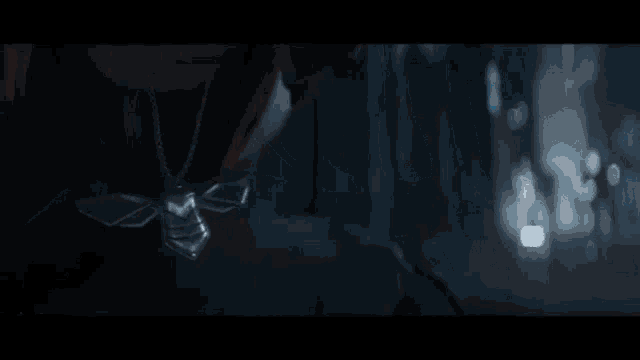 a group of people are standing in a dark room in a video game scene .