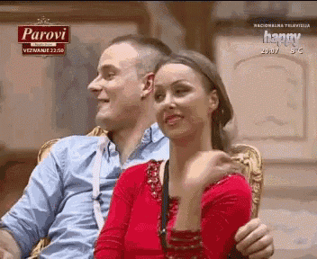 a man and a woman are sitting next to each other on a parovi television show