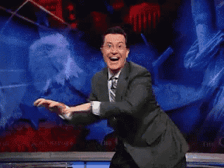 a man in a suit and tie is dancing on stage