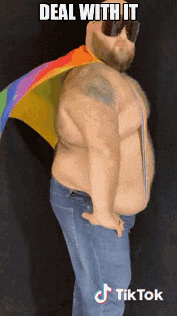 a man wearing sunglasses and a rainbow cape with the words deal with it written above him