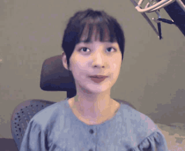 a girl with a bun in her hair is looking at the camera