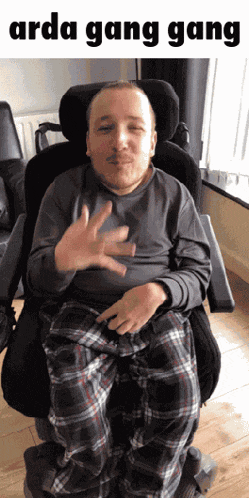 a man in a wheelchair with the words arda gang gang written above him