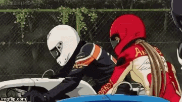 a man and a woman are riding motorcycles and the woman is wearing a red helmet that says ak on the back