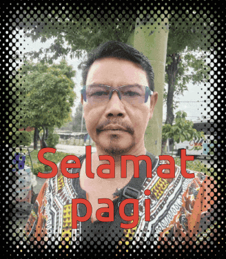 a man wearing glasses and a shirt with the words selamat pagi written on it