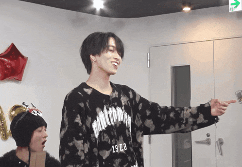 a man wearing a black sweater that says 1973 on it