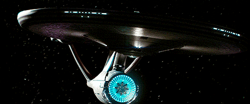 a large space ship with a blue light on the front