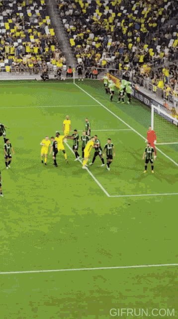 a blurry picture of a soccer game with the website gifrun.com