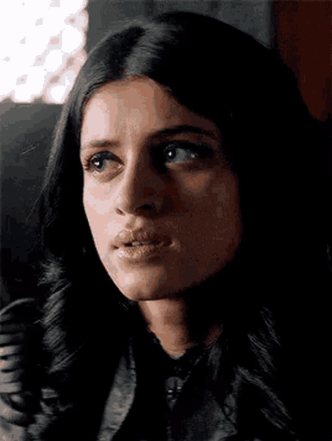 a close up of a woman 's face with a slight smile on her face .