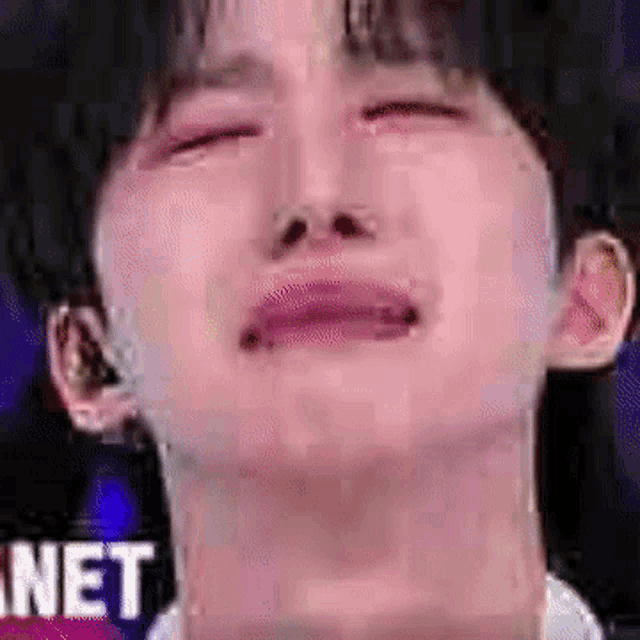 a close up of a person 's face with their eyes closed and tears running down their face .