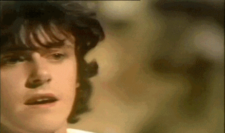 a close up of a young man 's face with a blurred background