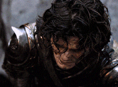 a close up of a person wearing armor with a sword