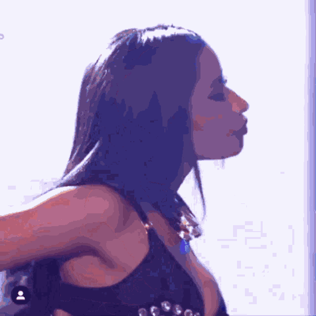 a close up of a woman 's face with a purple background and a person 's face in the corner