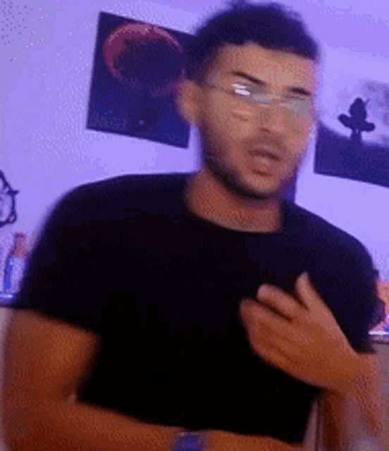 a blurry picture of a man wearing glasses and a black t-shirt