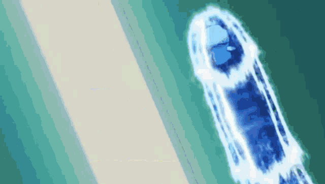 an aerial view of a boat floating in the ocean